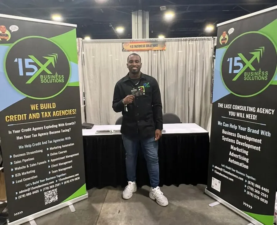 15X Business Solutions exhibition booth with branded banners listing its services